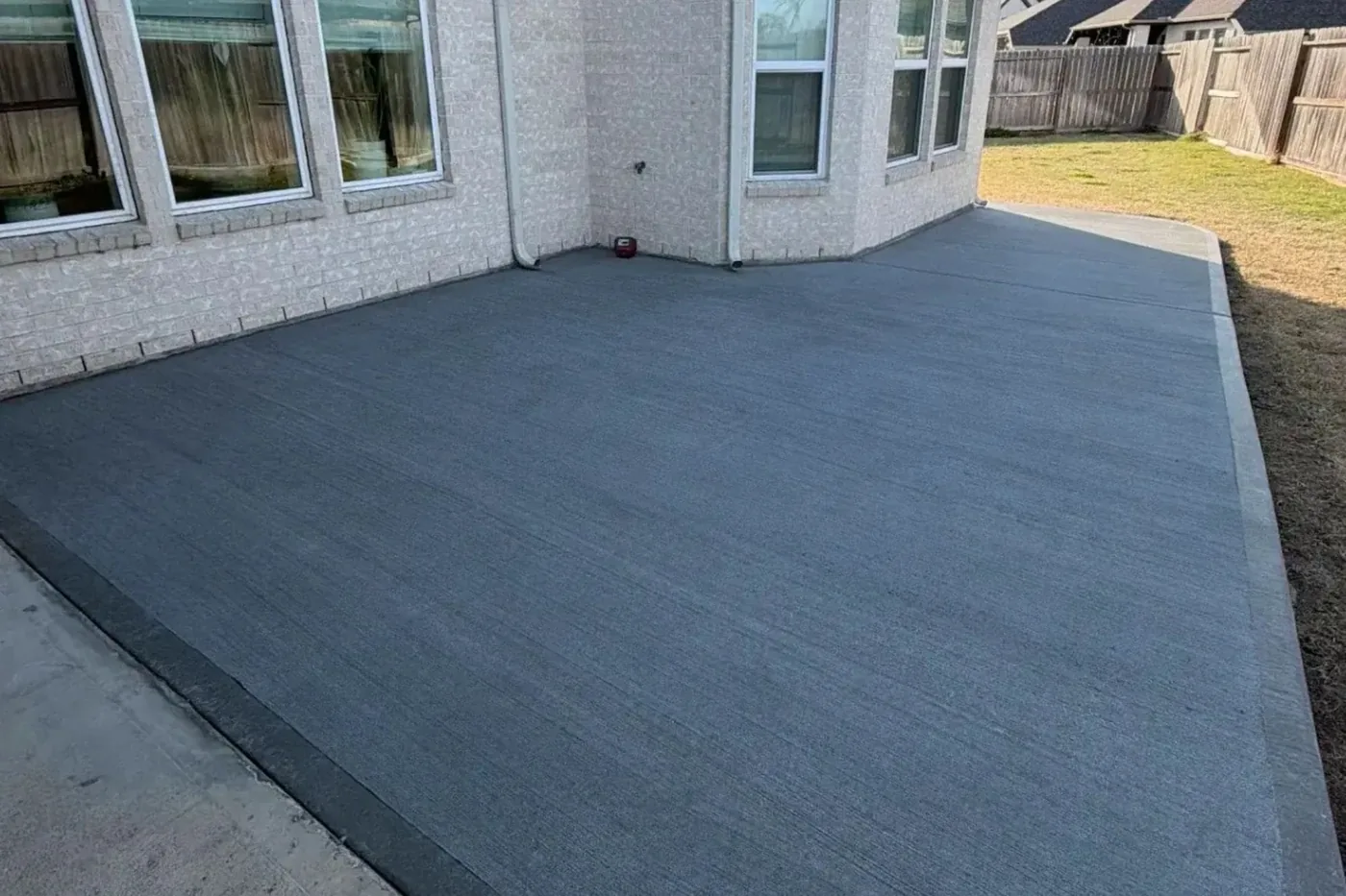 Finished broom-finish residential concrete patio by Lucky's Concrete